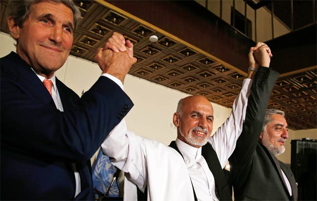 John kerry with afghan puppets