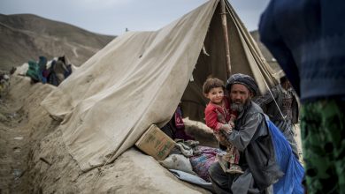 A displaced villager and his child in a tent after a landslide devastated their village, in abi barak, badakhshan province, afghanistan.