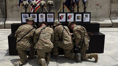 U.s. Soldiers Kneel At Memorial To Fallen Comrades In Afghanistan