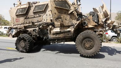 An Afghan Photographer Takes Picture Of A Damaged Danish Convoy At The Site Of A Car Bomb Attack In Kabul, Afghanistan